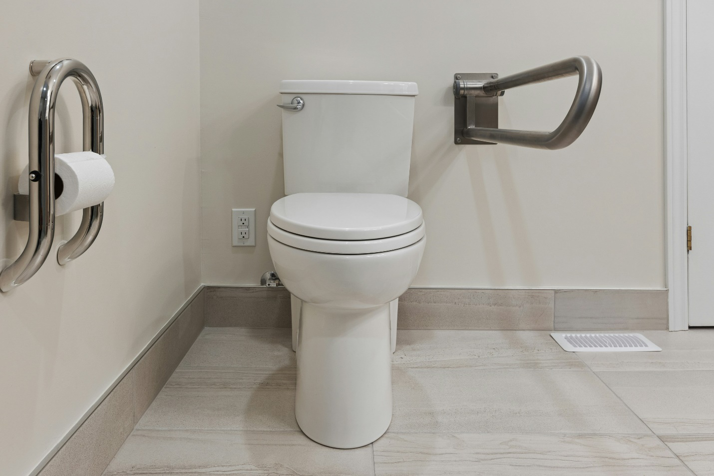 Metal support bars installed near a toilet.